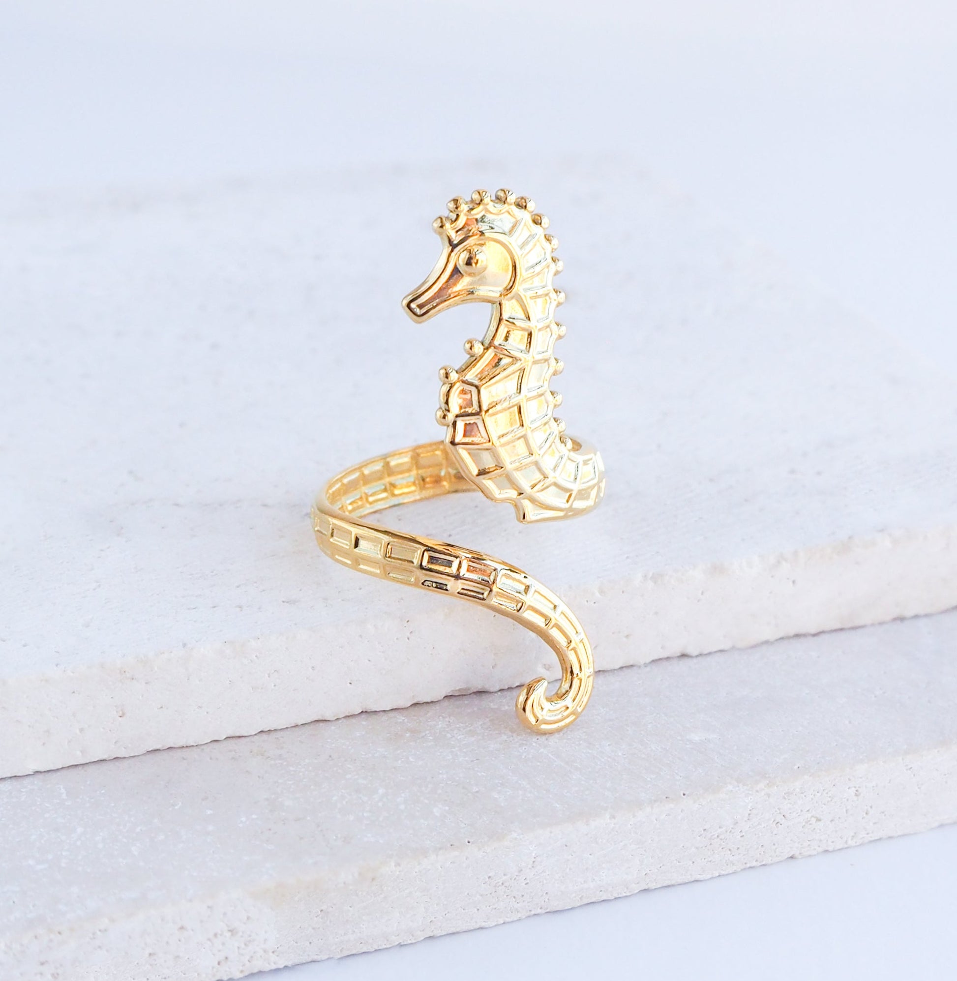 Close up of Gold seahorse ring on stone background, hippocampus ring 14k gold stainless steel