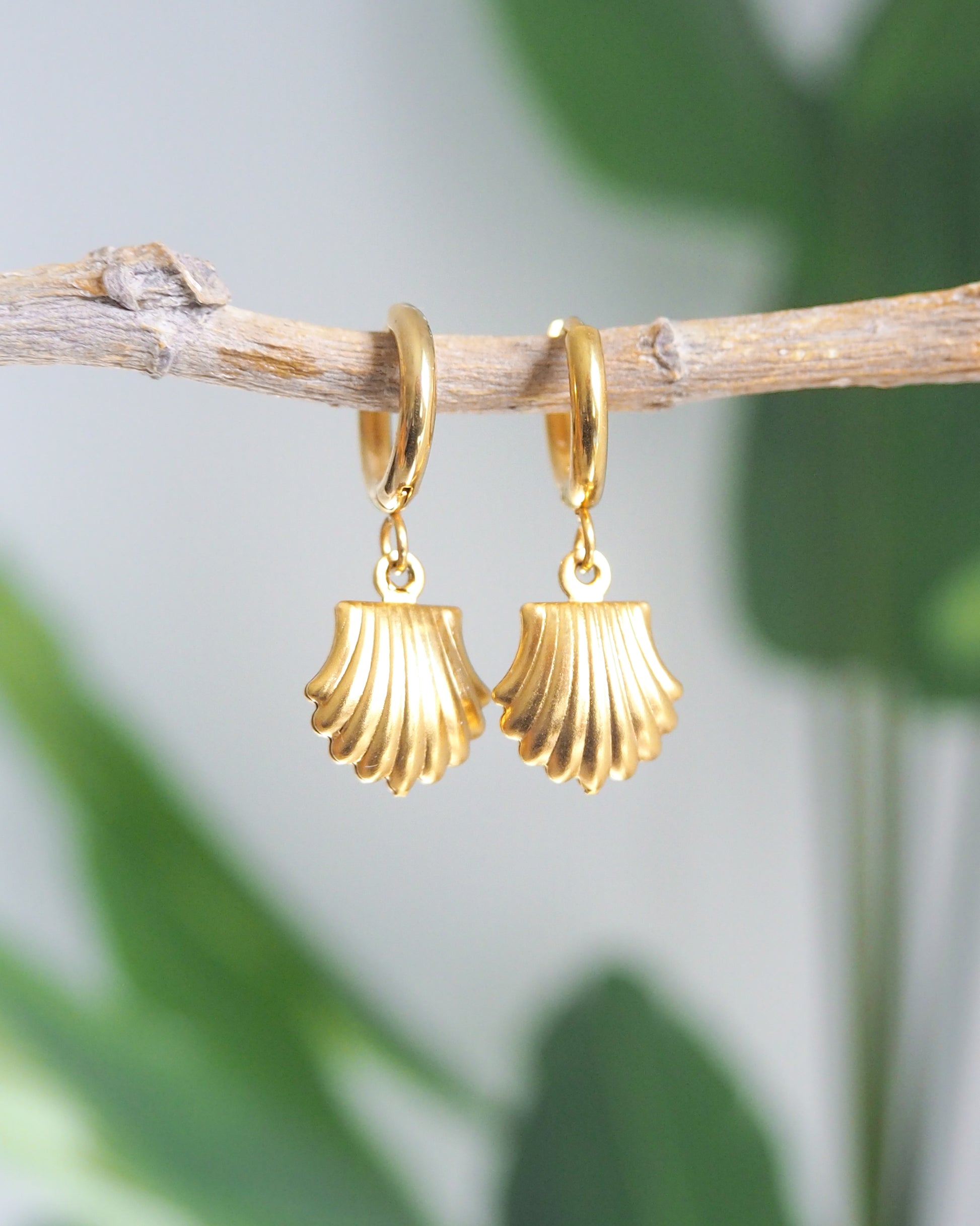 Gold Shell Earrings with green plant background, seashell pendant earrings, waterproof beach jewelry