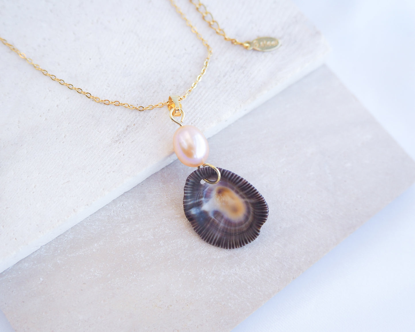 Striped Limpet Shell Rose Pearl Necklace on display, Dark Limpet Shell from Portugal with freshwater pearl and gold chain. 
