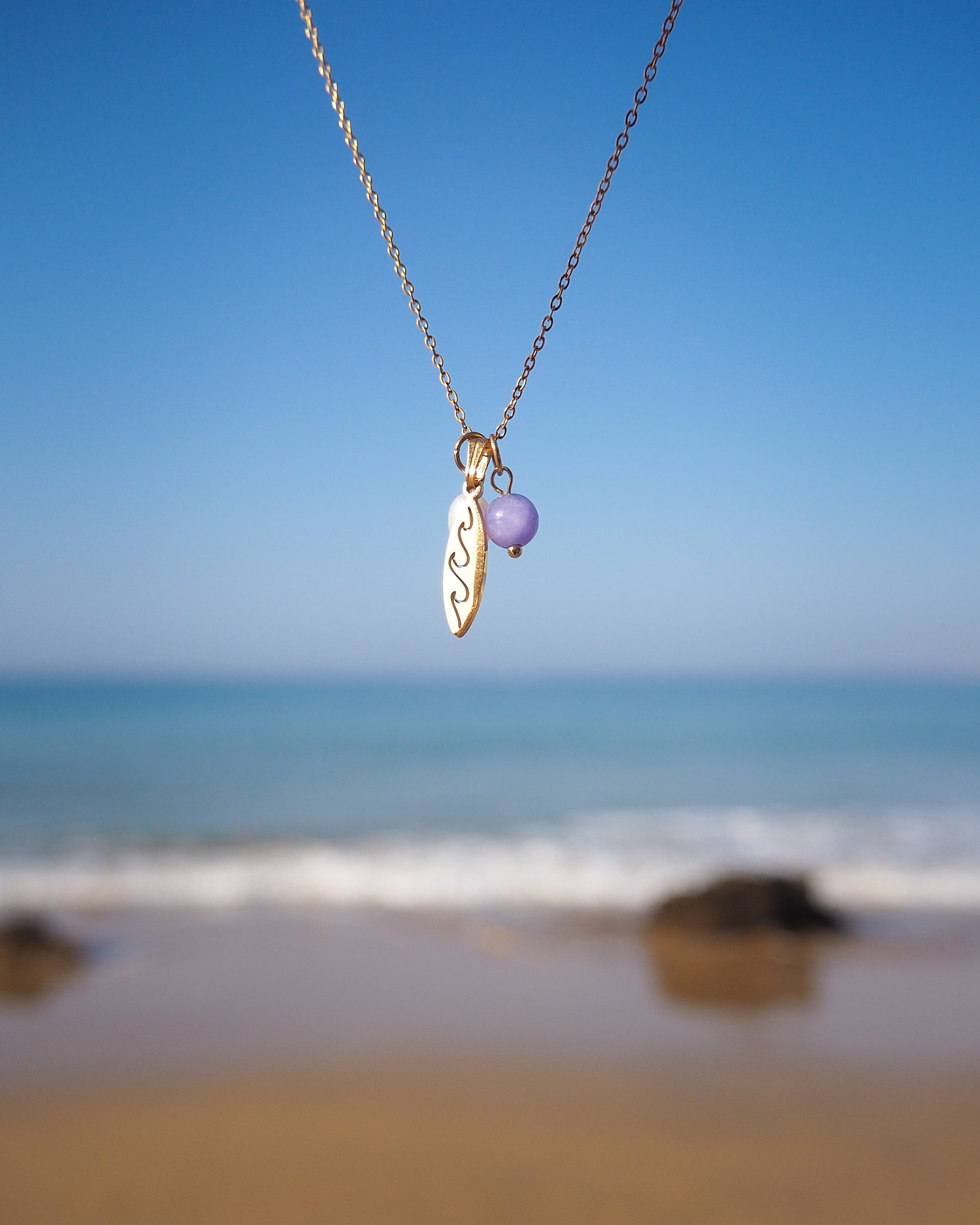 Gold Surfboard Pearl Angelite Gemstone Necklace with ocean background, Surfgirl Jewelry gift idea, stainless steel 