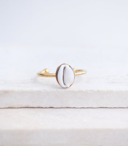 Close up front view of European Cowrie Shell Gold Ring Small from Portugal on stone display, Handpicked Spotted Cowrie Shell from Portugal, Gold Stainless Steel ring with tiny cowrie shell, Gift for beach girls