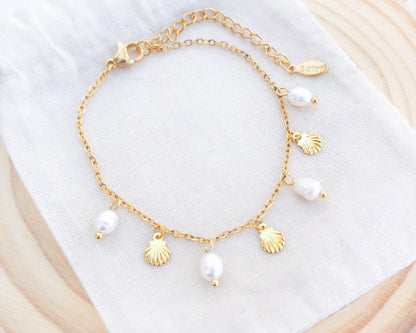 Gold Tiny Shell Ivory White Freshwater Pearl Bracelet on display, Dainty Gold Shell Bracelet