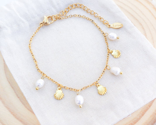 Gold Tiny Shell Ivory White Freshwater Pearl Bracelet on display, Dainty Gold Shell Bracelet