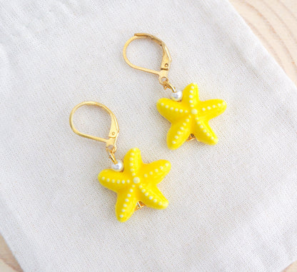 Gold Yellow Ceramic Starfish Sea Star Earrings on display