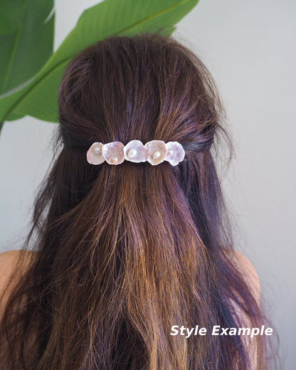 Model wearing a Jingle Shell Pearl Hair clip in brown hair with green plant background. Pearly shell Hair Clip Barrette made with pink fuchsia jingle shells from Portugal., Boho Seashell Beach Clip from Portugal, Handpicked Real Shells, Seashell Hair Decoration, Bohemian Seashell Wedding Hair Assocciares, Coastal Christmas gift, Beach Wedding Hair