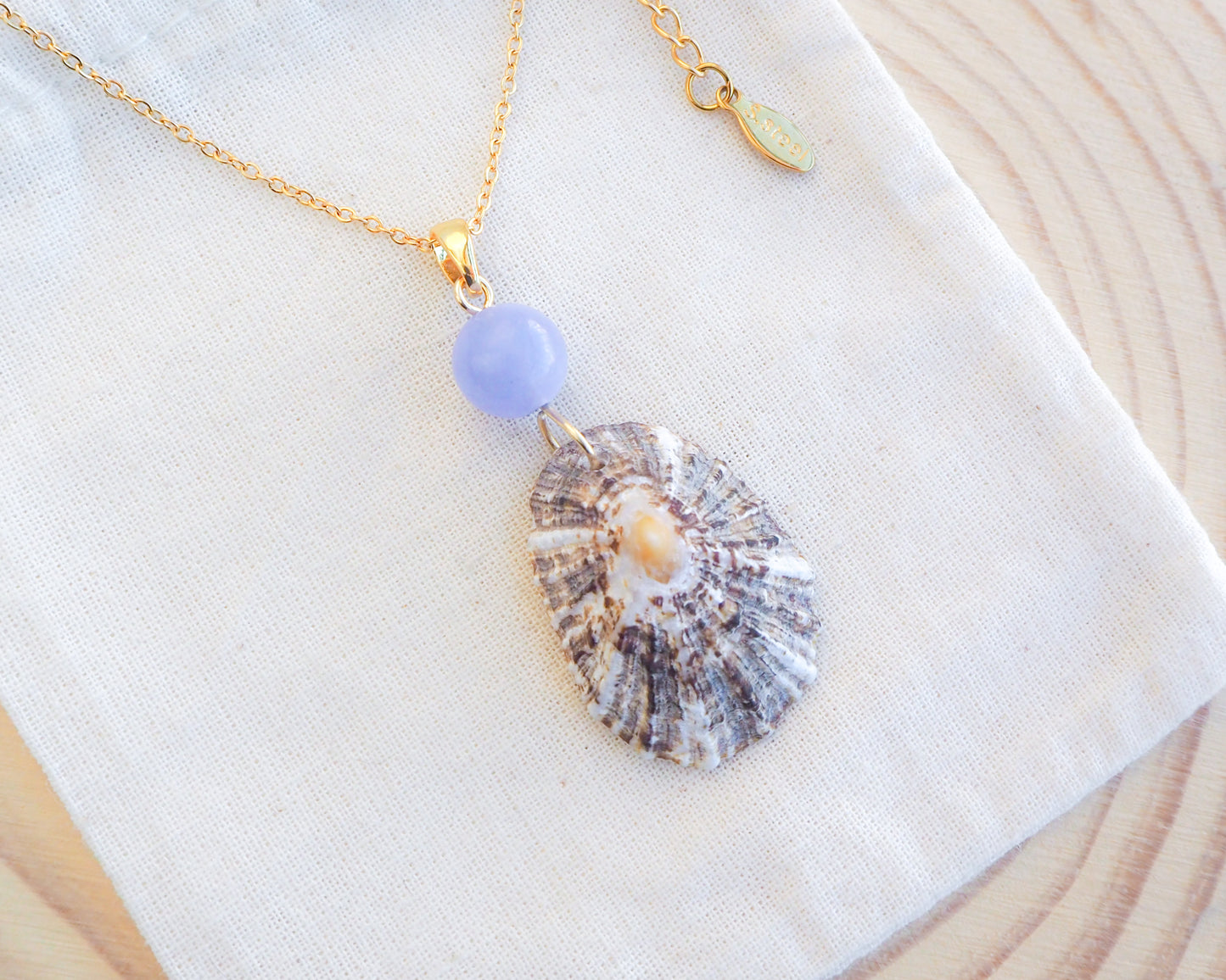 Limpet Shell Necklace with Blue Angelite Gemstone on display