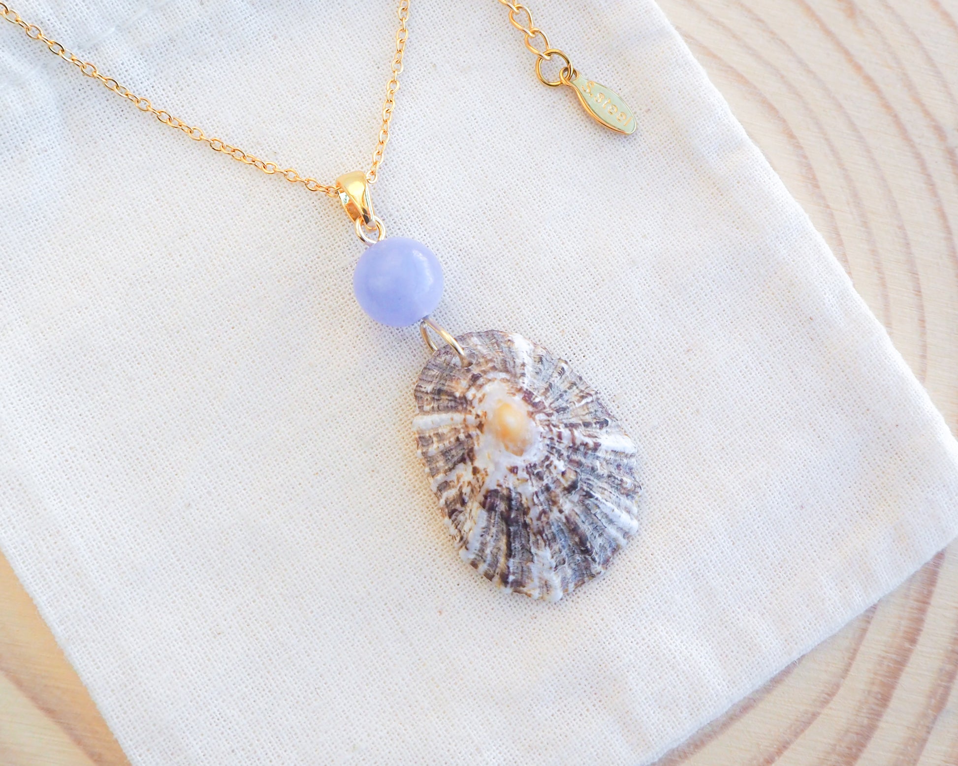 Limpet Shell Necklace with Blue Angelite Gemstone on display