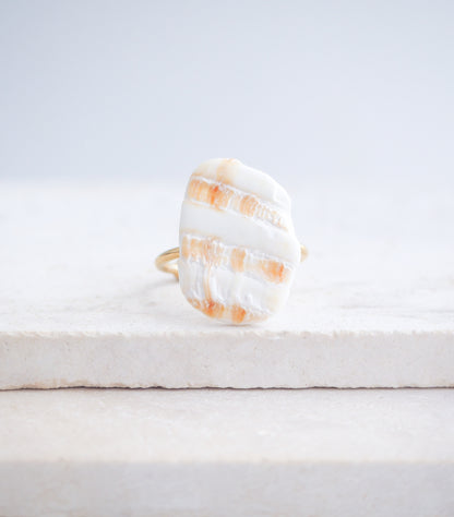 Mediterranean Cockle Shell Piece Gold Ring from Portugal on stone displayed, beach surf girl jewelry, gold ring with Portuguese cockle shell, ocean inspired beach jewelry, sunny yellow orange shell from Algarve