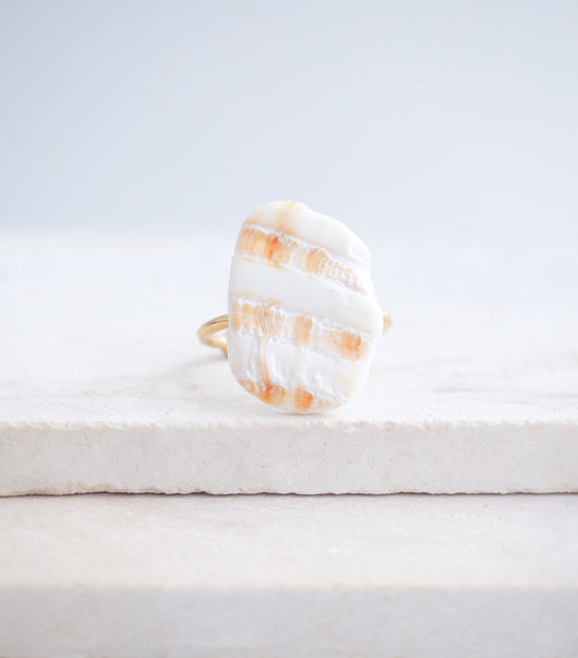 Mediterranean Cockle Shell Piece Gold Ring from Portugal on stone displayed, beach surf girl jewelry, gold ring with Portuguese cockle shell, ocean inspired beach jewelry, sunny yellow orange shell from Algarve