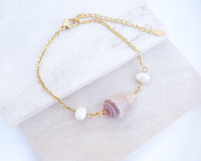 Gold Mediterranean Cone Shell Pearl Bracelet on display