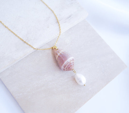 Mediterranean Cone Shell Pearl Necklace Reversed from Portugal on stone displayed, handpicked cone shell from Algarve, Freshwater pearl and 18k gold stainless steel chain