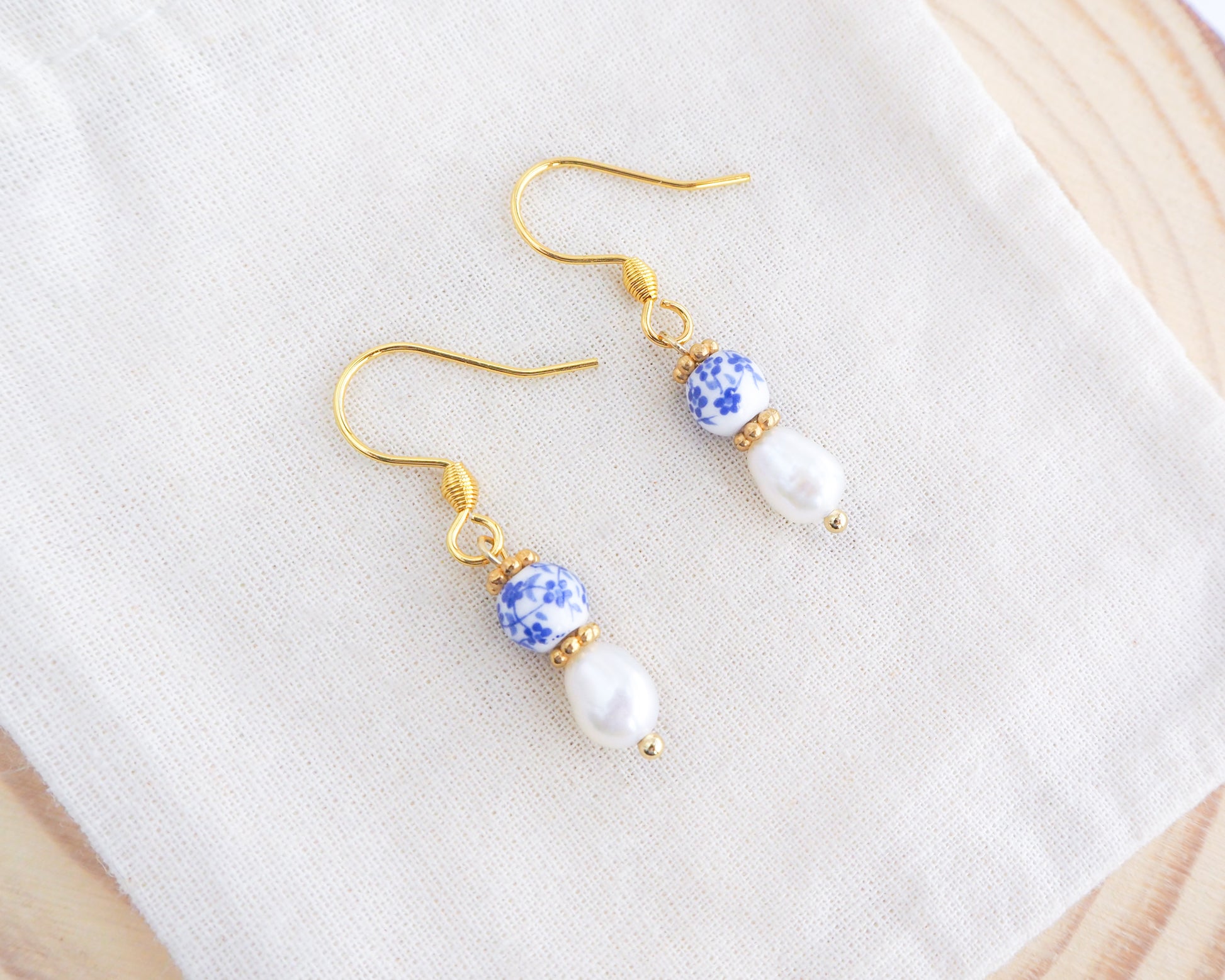 Portuguese Ceramic Pearl Gold Earrings Mini Azulejo Earrings from Portugal on display. Mini Azulejo Earrings from Portugal, Portuguese Tlles Jewelry, Blue White Flower Porcelain Earrings