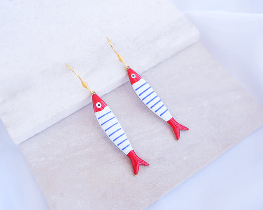 Nautical Striped Sardine Fish Earrings with 14k gold stainless steel earring hooks displayed on stone, Red Blue White Striped Fish Pendant, Beautiful gift for Portugal lovers or holiday memory, coastal jewelry from Portugal