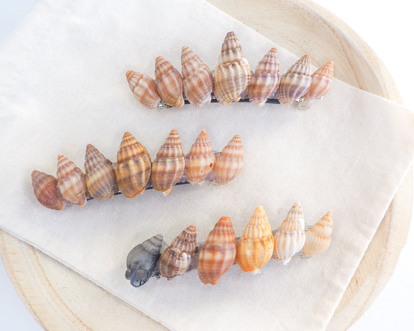Overview of Netted Dog Whelk Shells Hair Clip Barrette on stone displayed, Boho Seashell Beach Clip from Portugal, Handpicked Real Shells, Seashell Hair Decoration, Bohemian Seashell Wedding Hair Assocciares, Coastal Christmas gift, Beach Wedding Hair