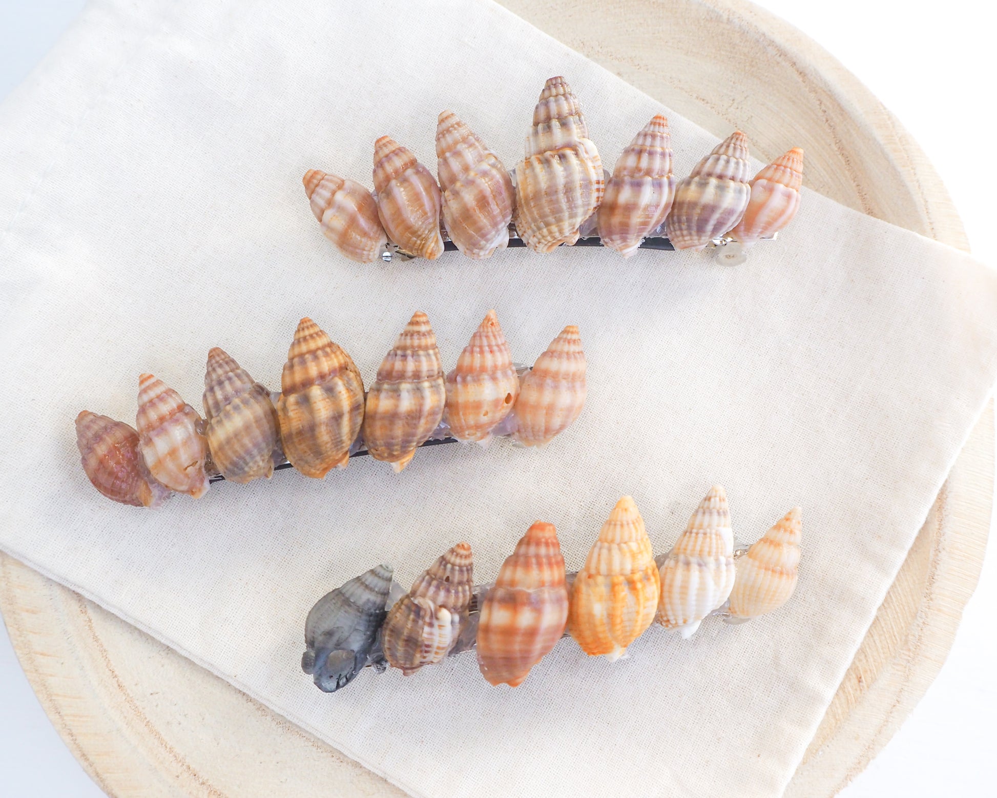 Overview of Netted Dog Whelk Shells Hair Clip Barrette on stone displayed, Boho Seashell Beach Clip from Portugal, Handpicked Real Shells, Seashell Hair Decoration, Bohemian Seashell Wedding Hair Assocciares, Coastal Christmas gift, Beach Wedding Hair