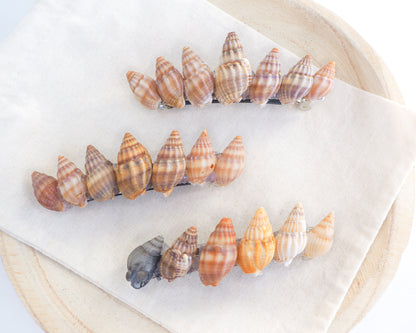 Overview of Netted Dog Whelk Shells Hair Clip Barrette on stone displayed, Boho Seashell Beach Clip from Portugal, Handpicked Real Shells, Seashell Hair Decoration, Bohemian Seashell Wedding Hair Assocciares, Coastal Christmas gift, Beach Wedding Hair
