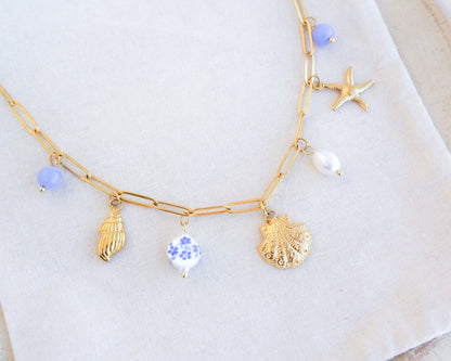 Oceanic Charm Necklace with Shells and Starfish Pendants, Freshwater Pearls and Gemstones on display