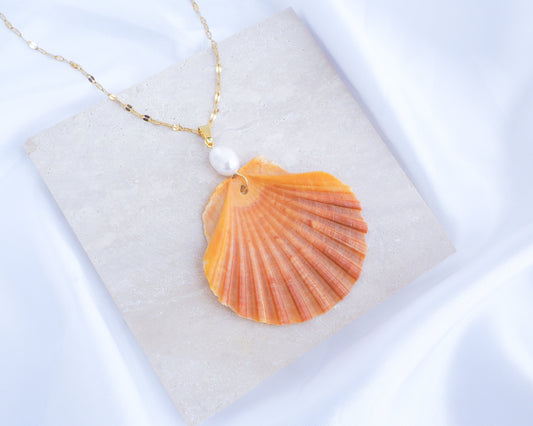 Orange Scallop Shell Pearl Gold Necklace on display, Pilgrims Scallop Shell from Portugal with freshwater pearl and gold chain. 