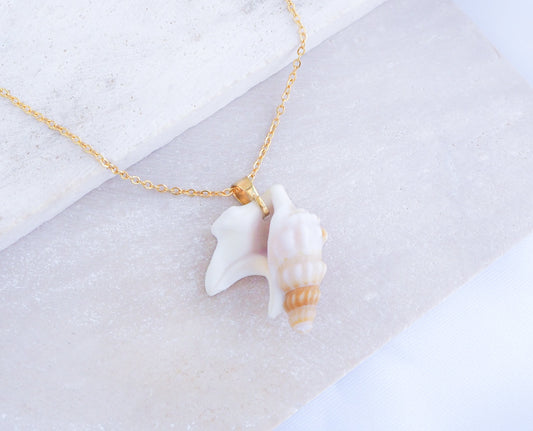 Pelicans Foot Gold Necklace from Portugal displayed on stone