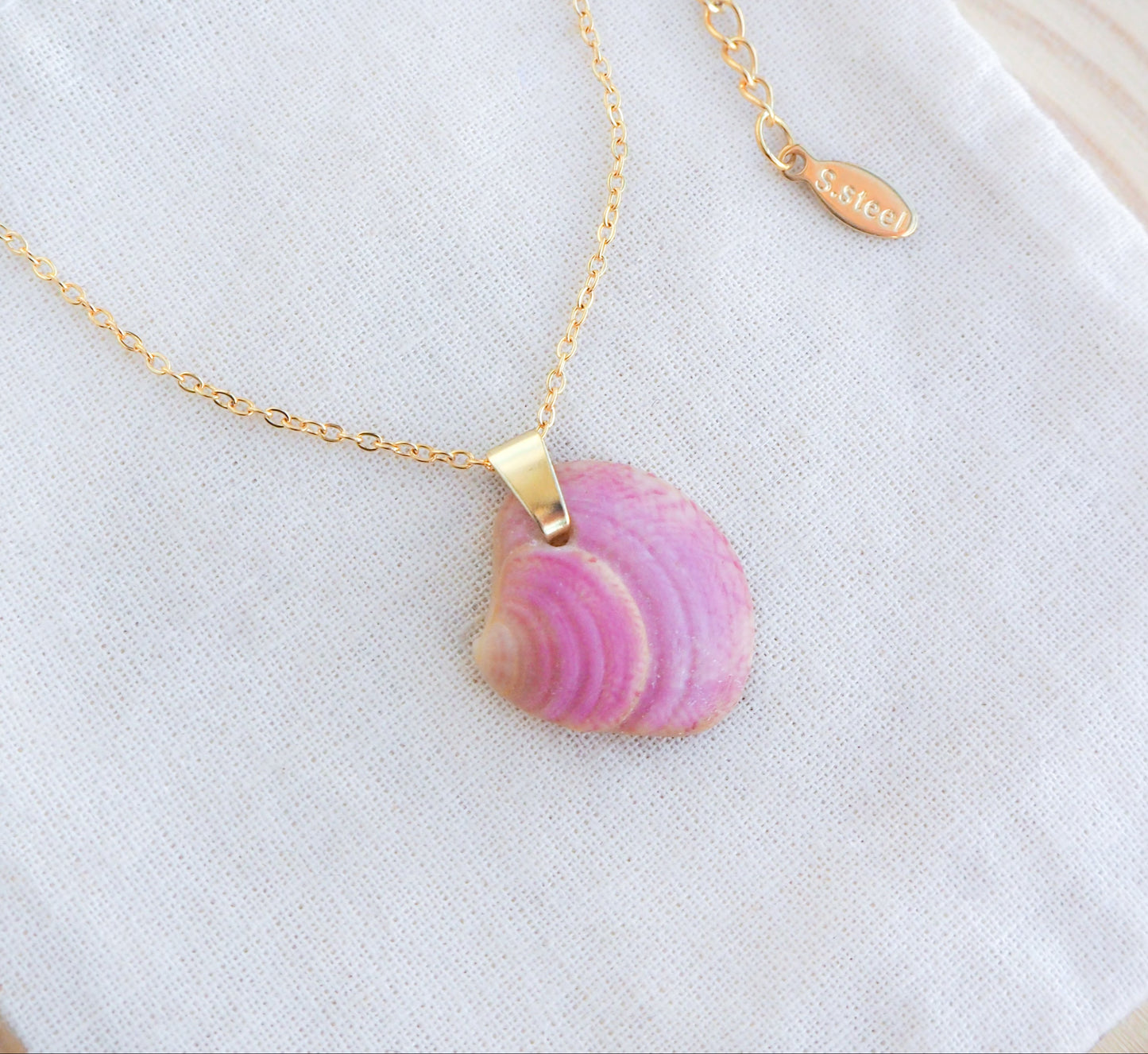 Pink Raspberry Venus Shell Necklace on display