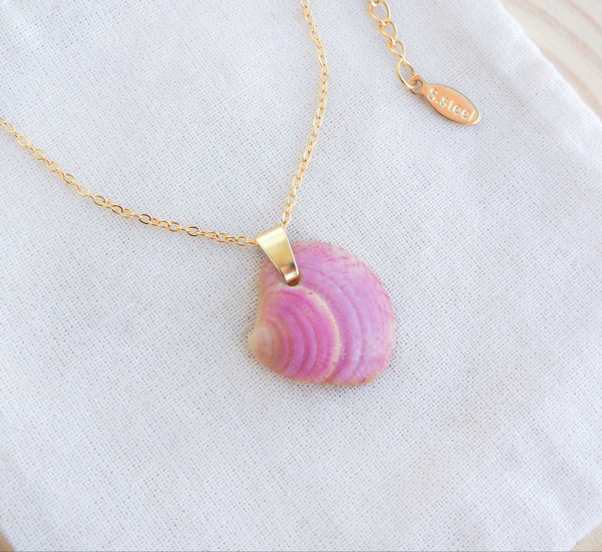 Pink Raspberry Venus Shell Necklace on display