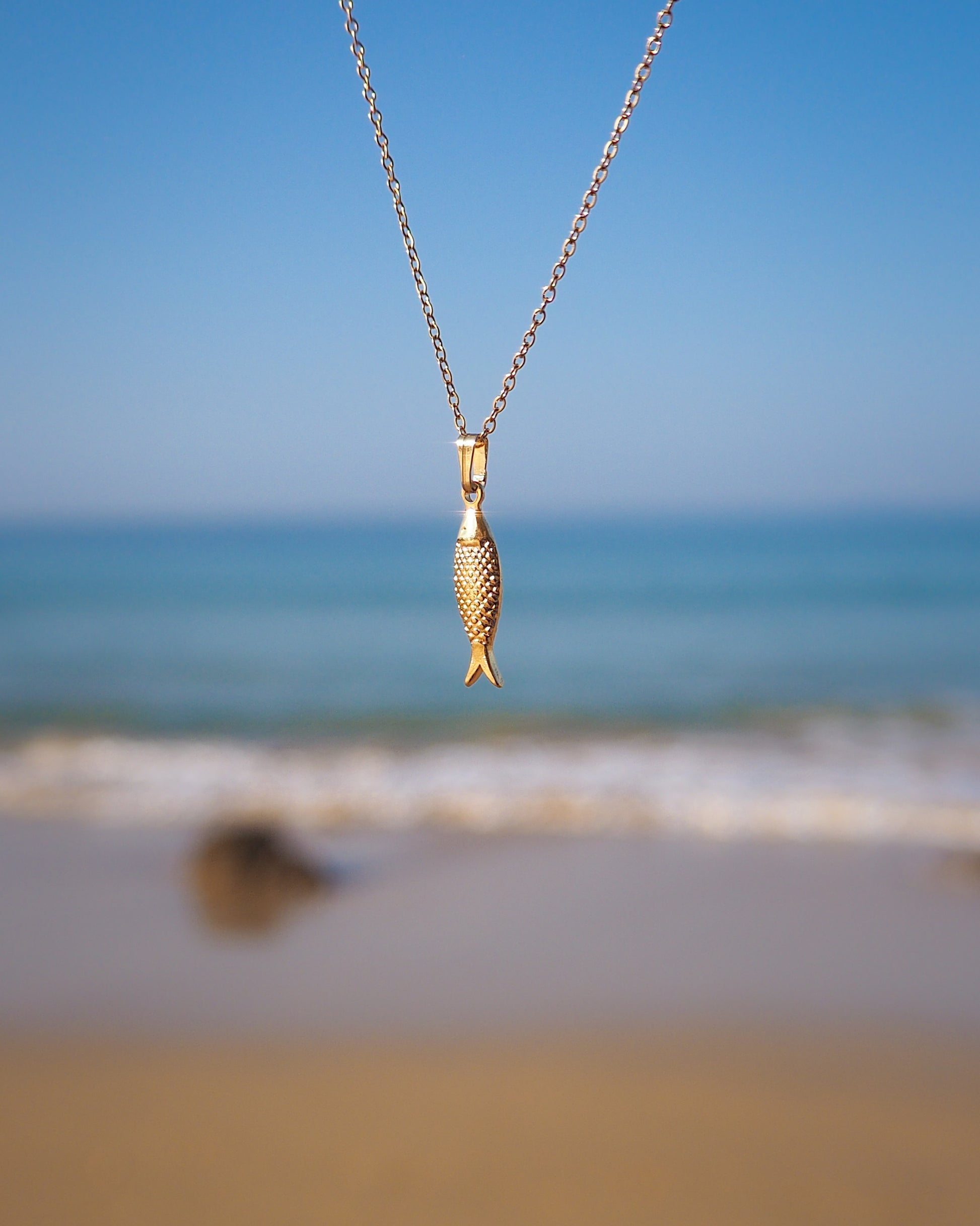 Gold Sardine Fish pendant necklace with ocean view background, Sardine Fish Necklace, Christian Fish Jewelry, Pisces Zodiac Gift, Portuguese Sardine Jewelry, Gift for Portugal Lovers, 