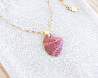 Raspberry Fuchsia Venus Shell Gold Necklace on display 