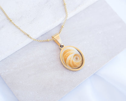 Yellow Orange Eye of Saint Lucia Gold Necklace on stone displayed, 18k gold stainless steel shiva Yellow Orange eye pendant necklace, Saint Lucy Eye, operculum pendant