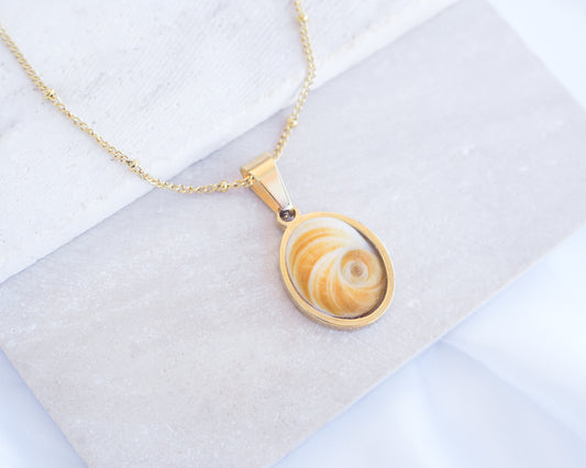 Yellow Orange Eye of Saint Lucia Gold Necklace on stone displayed, 18k gold stainless steel shiva Yellow Orange eye pendant necklace, Saint Lucy Eye, operculum pendant