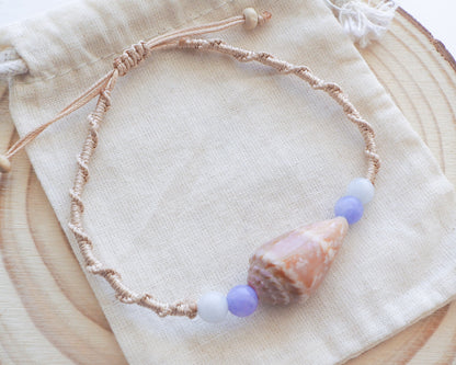 Angelite Cone Shell Bracelet. Handbraided macrame bracelet with handpicked cone shell from Portugal and gemstone beads on display.