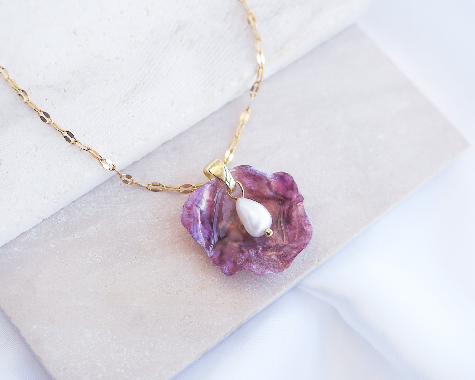 Close up of Fuchsia Pink Pearl Shell Necklace VII displayed on stone, Gold Pearly Pink Oyster Shell Necklace, Fuchsia Pink Pearly Shell handpicked from Portugal, Sea by Lou, Mother of Pearl Shell Portugal 