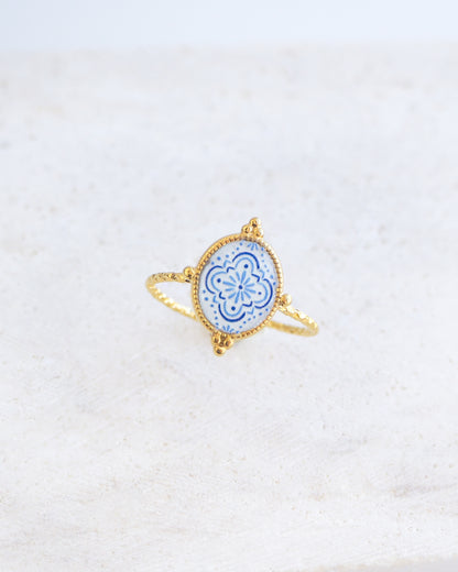 Side view of Blue White Portuguese Tile Oval Rings on stone displayed. The ring is handmade with 18k gold stainless steel and are made with different patterns inspired by the Portuguese azulejos tiles. 
