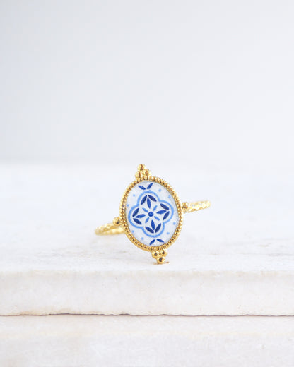 Blue Portuguese Tile Oval Rings on stone displayed. The ring is handmade with 18k gold stainless steel and are made with different patterns inspired by the Portuguese azulejos tiles. 