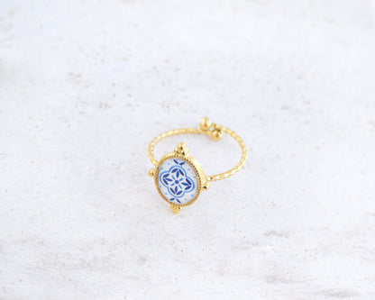 Side view of Blue Portuguese Tile Oval Rings on stone displayed. The ring is handmade with 18k gold stainless steel and are made with different patterns inspired by the Portuguese azulejos tiles. 