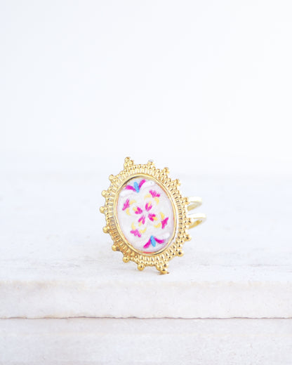 Front view of Fuchsia Portuguese Tile Oval Deluxe Rings on stone displayed. The ring is handmade with 18k gold stainless steel and are made with different patterns inspired by the Portuguese azulejos tiles. 