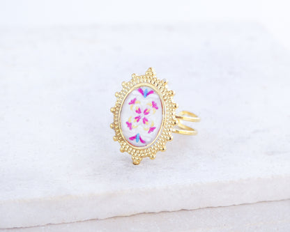 Side view of Fuchsia Portuguese Tile Oval Deluxe Rings on stone displayed. The ring is handmade with 18k gold stainless steel and are made with different patterns inspired by the Portuguese azulejos tiles. 