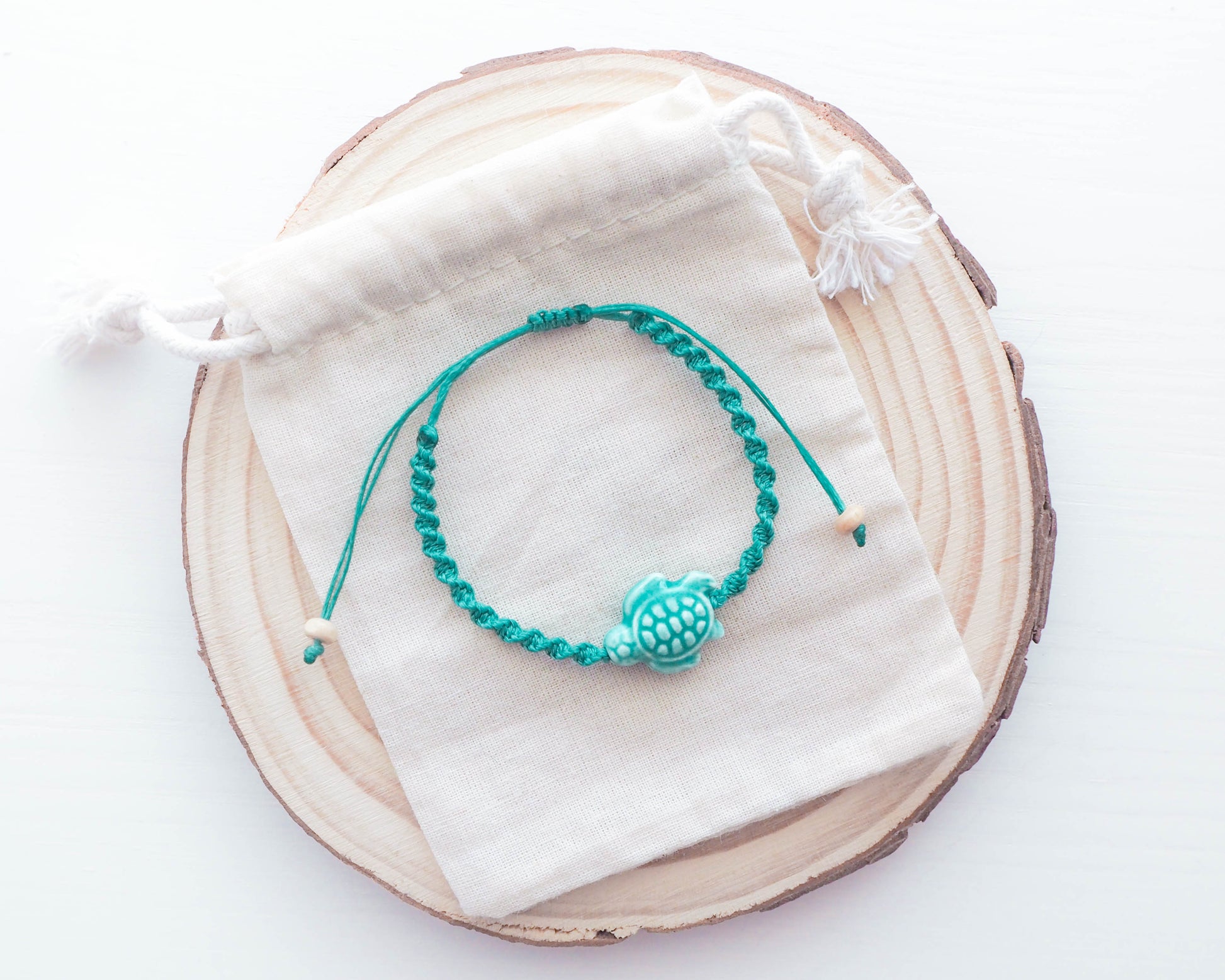 A high-resolution image showcasing the braided band of the Turquoise Green Ceramic Turtle Braided Bracelet. The band is earthy and textured, creating a harmonious contrast with the ceramic turtle