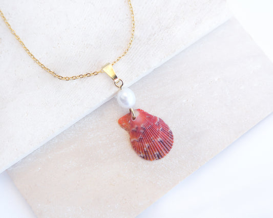 Tiny Red Orange Scallop Shell Pearl Necklace. Made with a handpicked scallop shell from Portugal and adorned with a ivory white freshwater pearl displayed on stone.