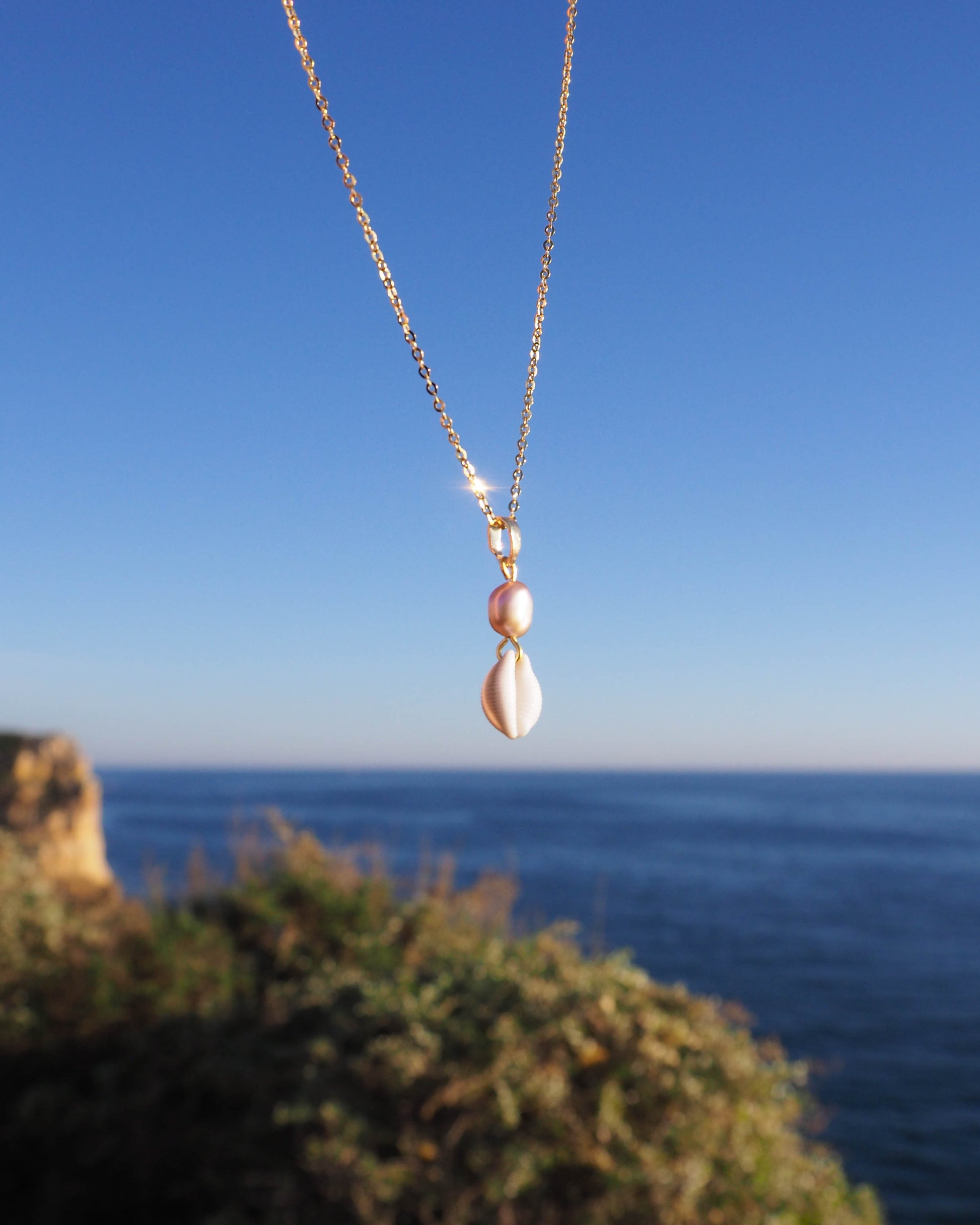 Gold Cowrie Shell Pearl Necklace, Champagne Freshwater Pearl outside in Portugal