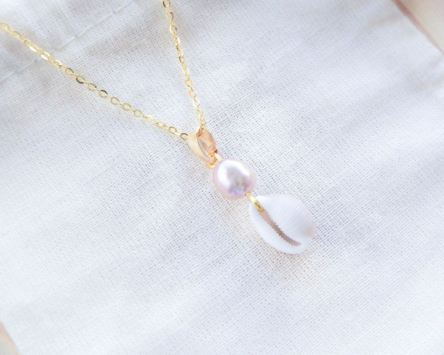 Close-up of Pendant: Freshwater Pearl and European Cowrie Shell on 925 Silver & 18K Gold-Plated Necklace