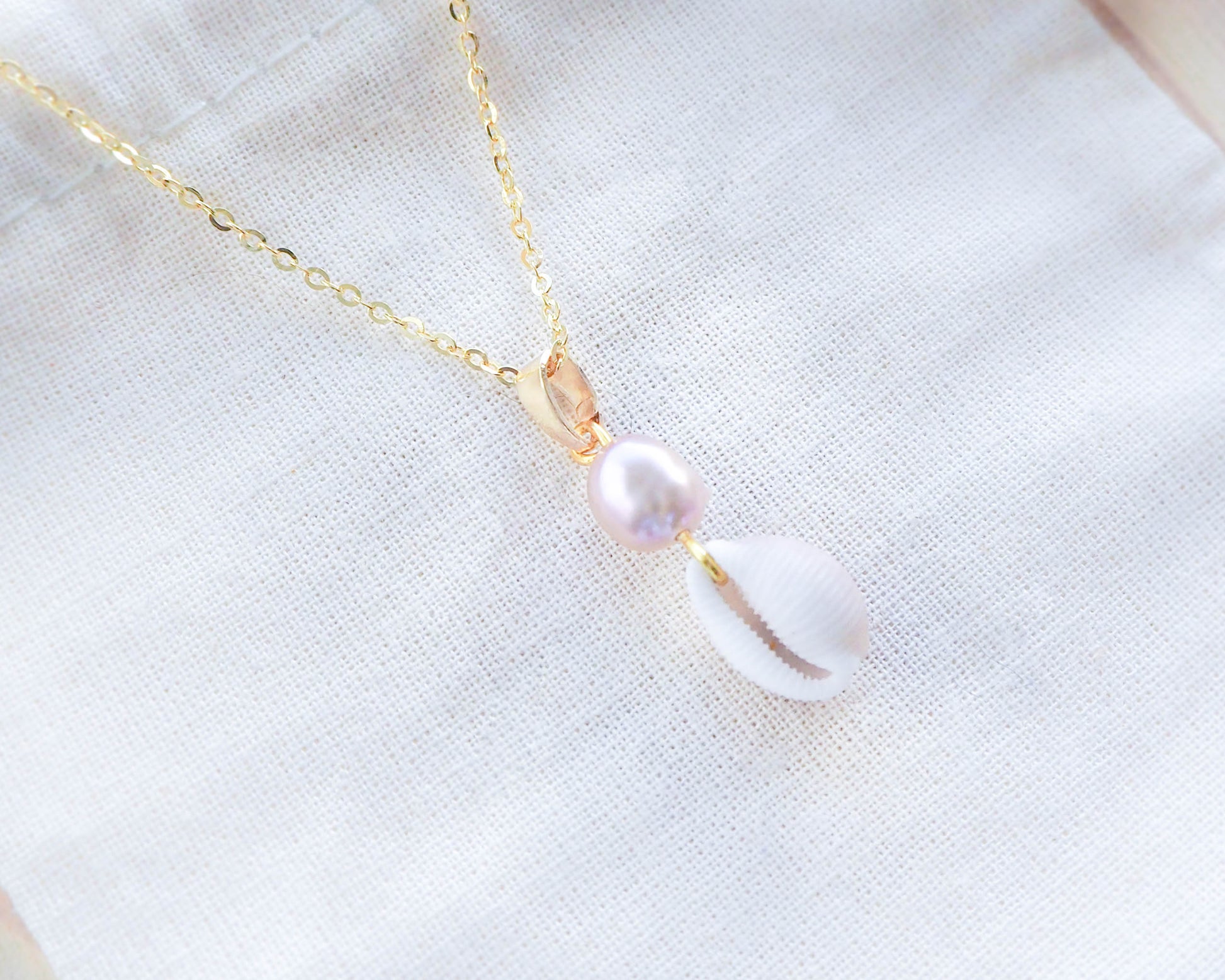 Close-up of Pendant: Freshwater Pearl and European Cowrie Shell on 925 Silver & 18K Gold-Plated Necklace