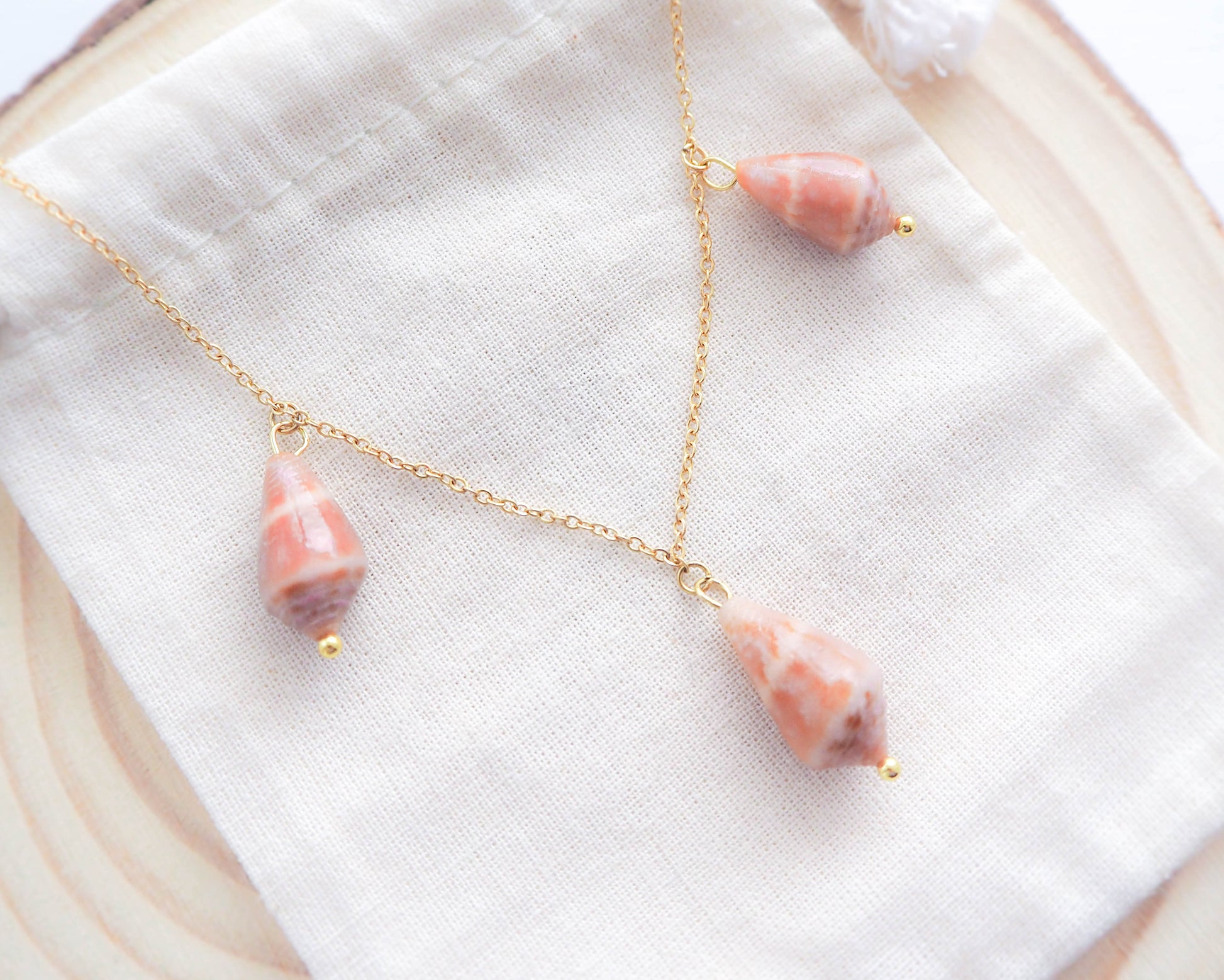 The Gold Stainless Steel Necklace elegantly displayed, showcasing its coastal charm and timeless elegance of the Mediterranean Cone Shell, Seabylou