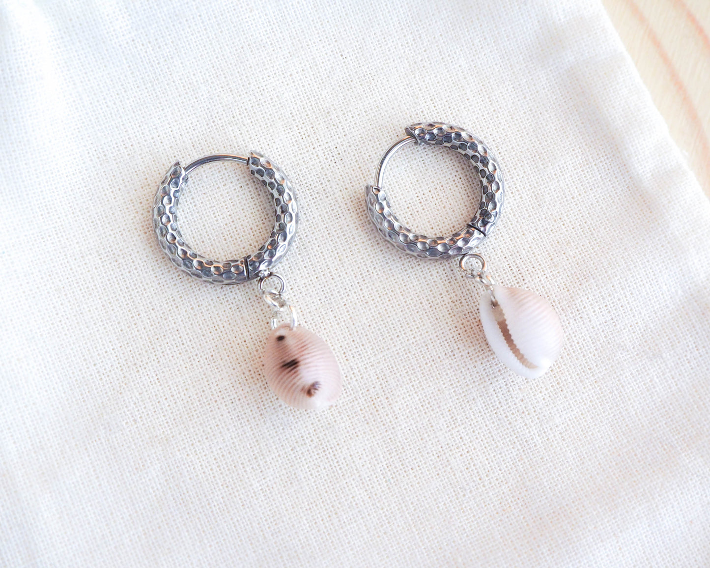 Close-up of European Cowrie Jewelry: Unique Silver Stainless Steel Earrings, Handcrafted from Portugal