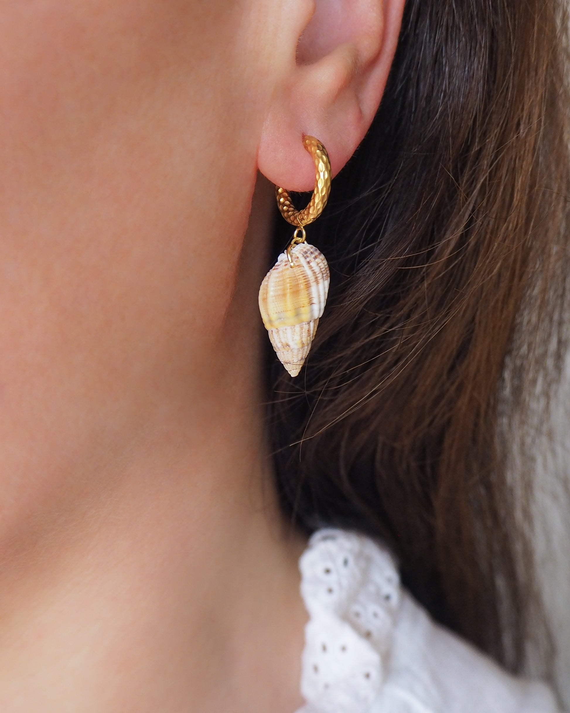 Gold Netted Dogwhelk Shell Earrings with Gold Hoop Hooks on model