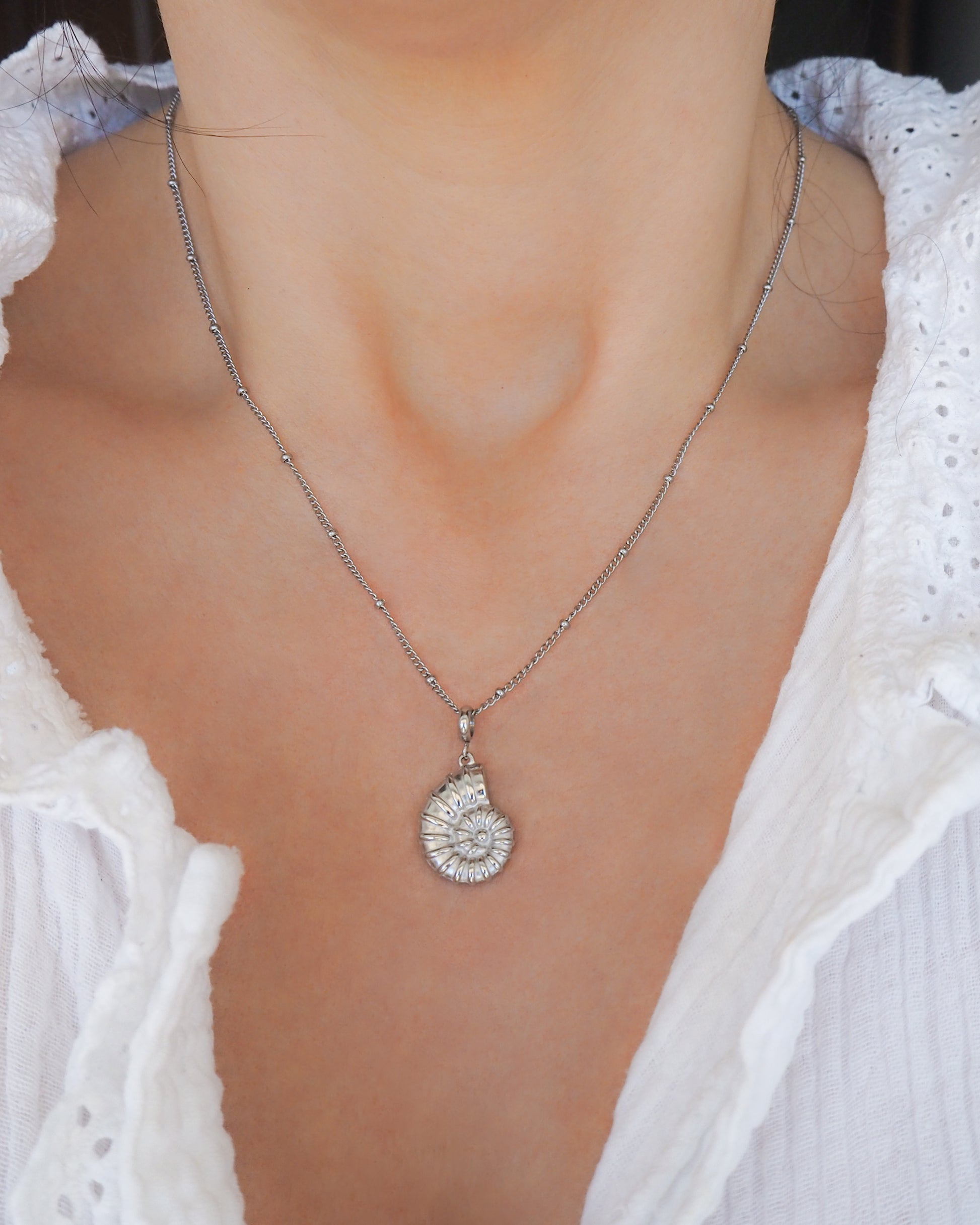 Silver Nautilus Seashell Necklace, Seabylou pendant on neck 