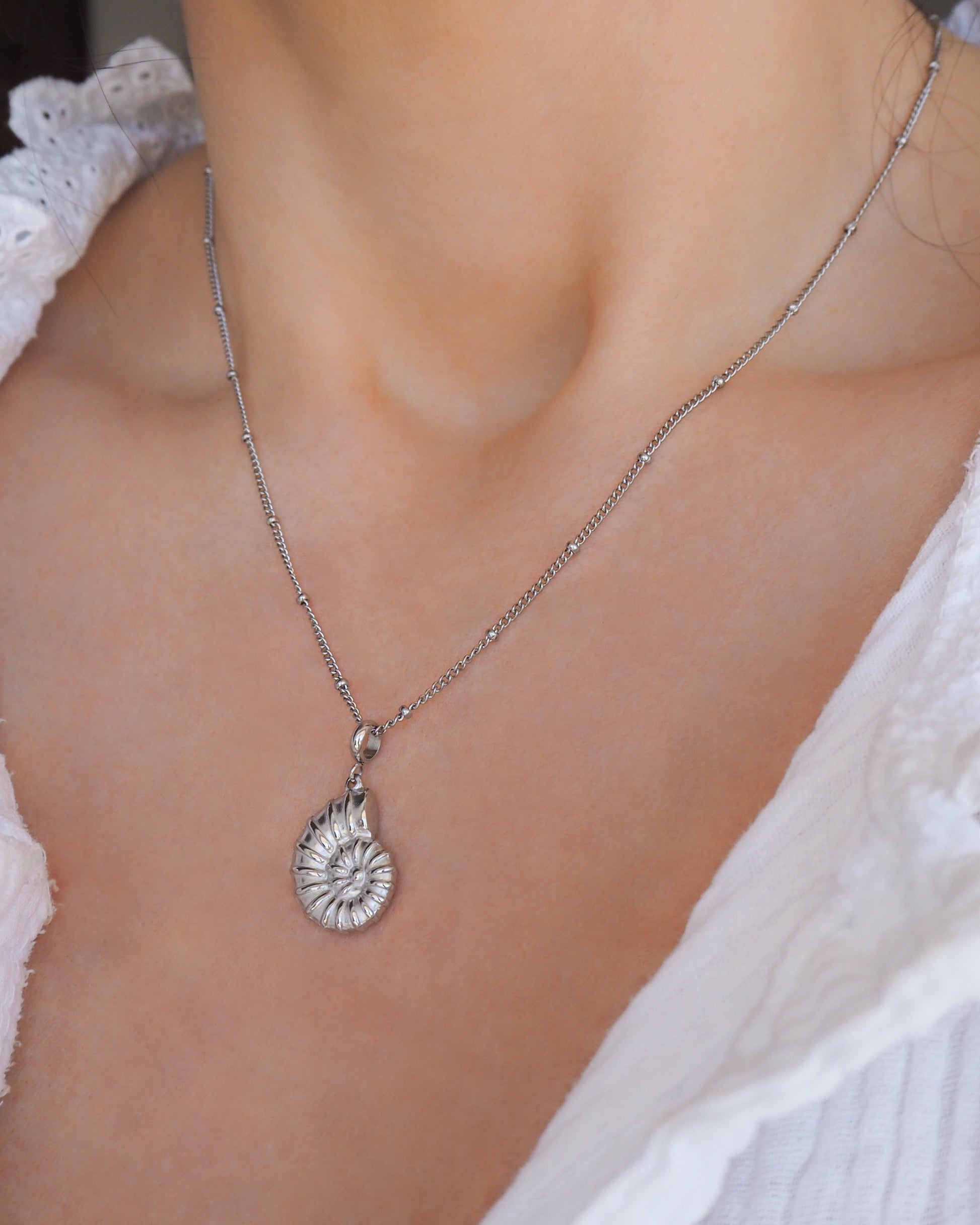 Silver Nautilus Seashell Necklace, Seabylou pendant on display on model