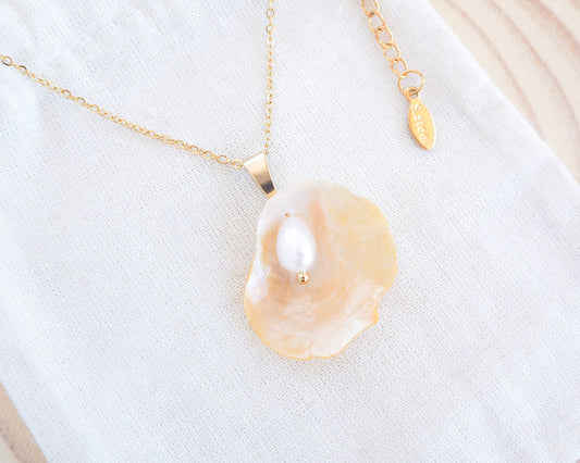 Soft Yellow Jingle Shell VI Gold Necklace on display, Mother of Pearl Pendant