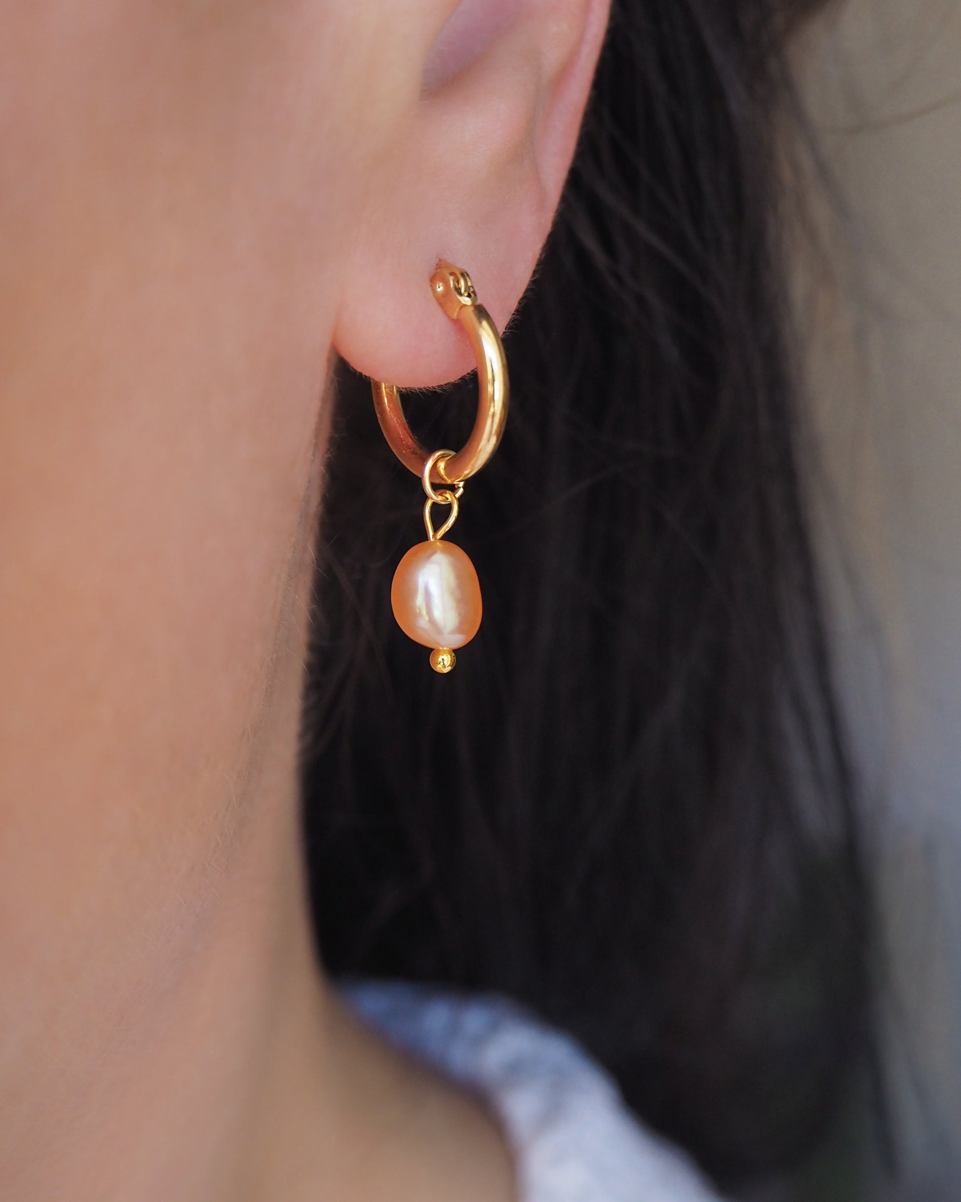 Close up Gold Rose Freshwater Pearl earrings in ear