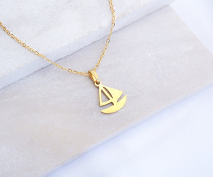 Gold Sailing Boat Necklace made with 14k gold stainless steel on display