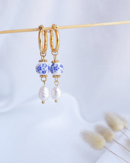 Gold hoop earrings with blue and white bead accents on a light background. Gold Ceramic Azulejo Pearl Earrings from Portugal, Portuguese Ceramic Tlle Jewelry